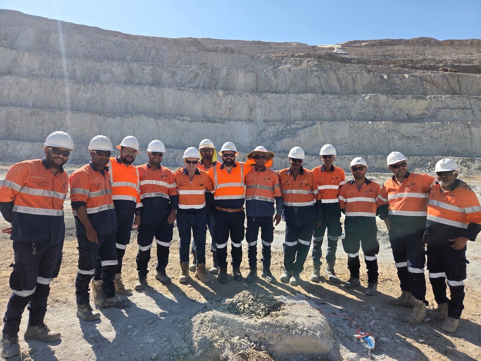 A blast design training group in front of a highwall at the Sukari gold mine.